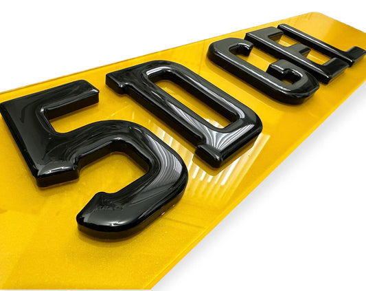 Black license plate letters on a yellow background