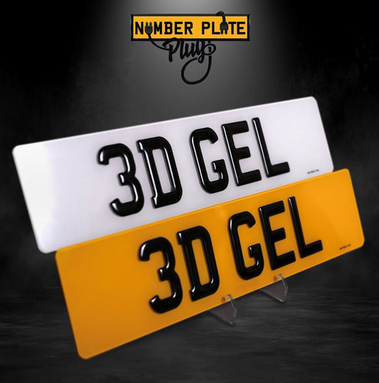 A display of two 3D gel number plates, one with black letters on a white background, and the other with white letters on a yellow background, both mounted on a stand.