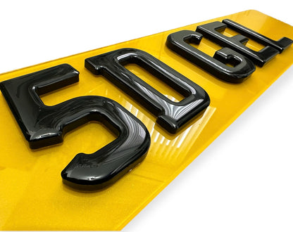 Black license plate letters on a yellow background
