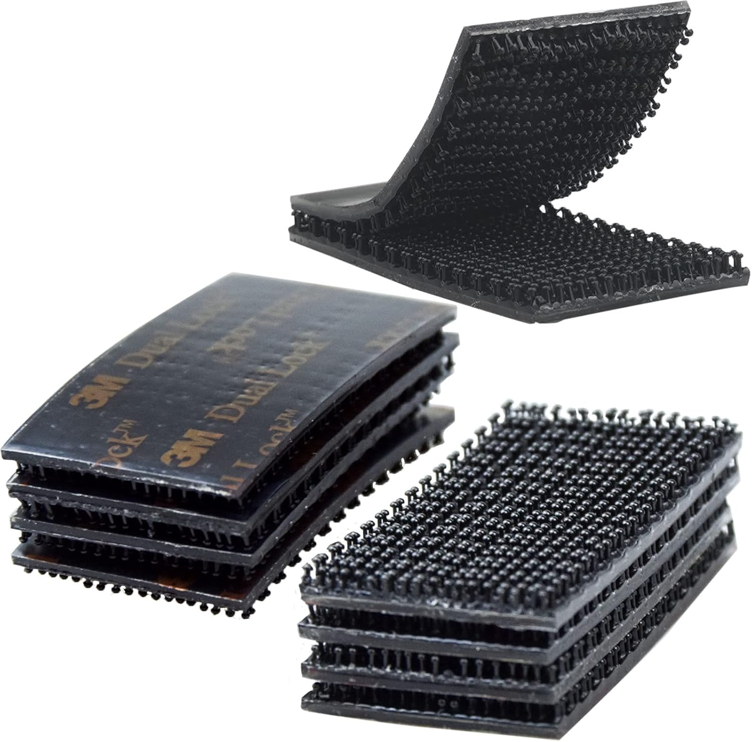 Stack of black adhesive strips with textured surface on a white background