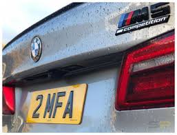 BMW car with a license plate '2MFA' and M Performance badge.