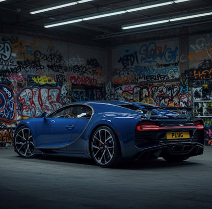 Blue sports car in a graffiti-covered garage
