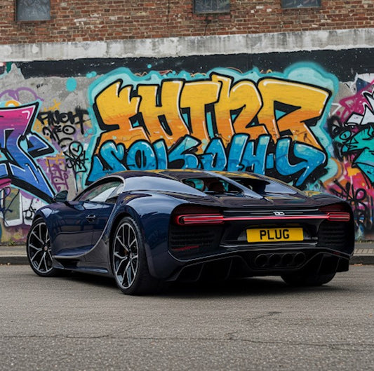 Black sports car with a yellow license plate in front of graffiti-covered walls.